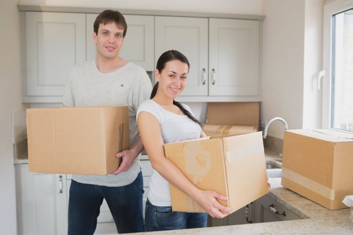 Team member wearing PPE while carrying furniture indoors
